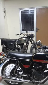 Old motorcycle is parked at home Stock Photos