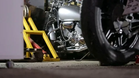 Old motorcycle seat falls down on the floor before reparing Stock Footage 82981119