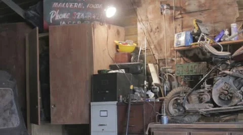 Old motorcycle sitting in shed Stock Footage 10708982
