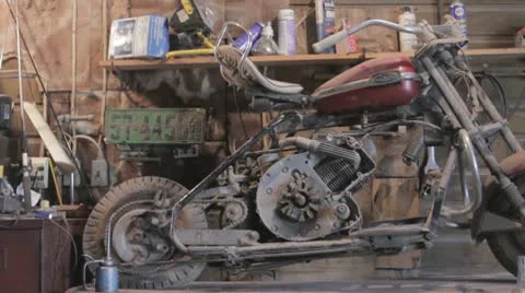 Old motorcycle sitting in shed Stock Footage 10708985