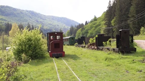Old mountain train station, train passing an abandoned old train Stock Footage 63378512