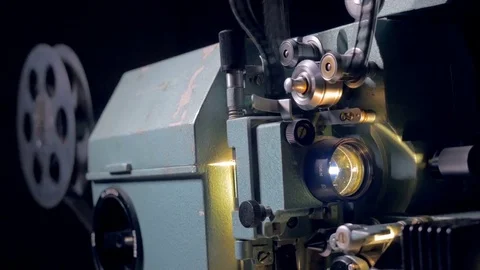 Old movie projector working in dark cinema hall. 4K. Stock Footage 80666763