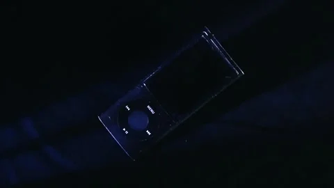 Old mp3 music player with a broken screen on a black background Stock Footage 338329149