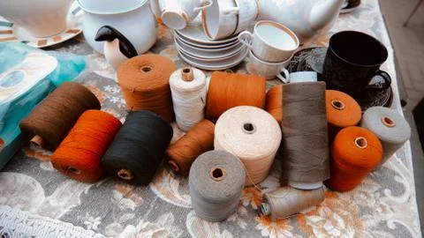 Old multi-colored threads for sewing in the market. Stock Photos