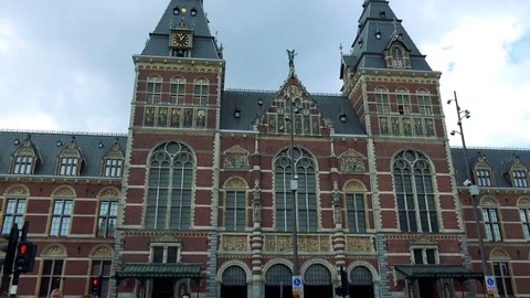 An old museum, the cloudy blue sky in the background, a street busy with people Stock Footage 73960203