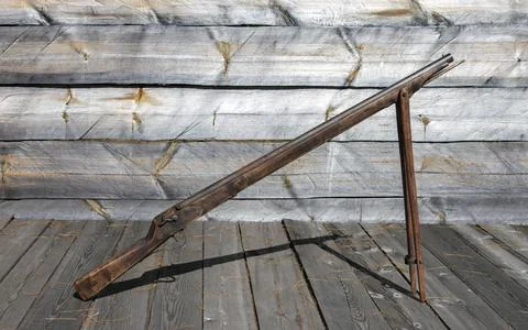 Old muzzle-loading percussion cap gun on wooden bipods in the yard of Siberia Stock Photos