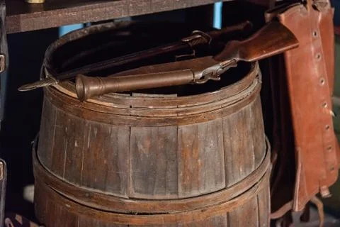 Old muzzleloader pistol standing on an antique wooden barrel Stock Photos