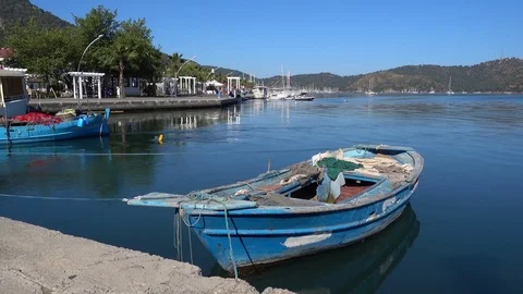 Old nameless boat rests on the berth Stock Footage