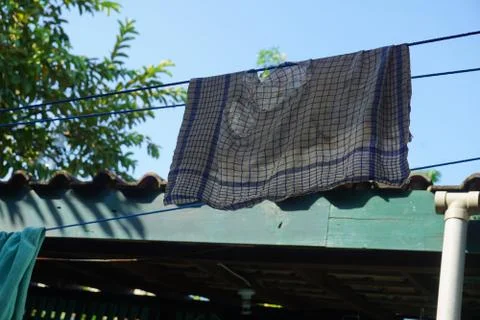 Old napkin was dried in the sun on the clothesline, in a tropical sunlight da Stock Photos