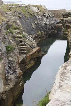 Old natural pool for breeding shellfish in Rinlo town, a small fishing vill.. Stock Photos