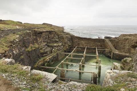 Old natural pool for breeding shellfish in Rinlo town, a small fishing vill.. Stock Photos