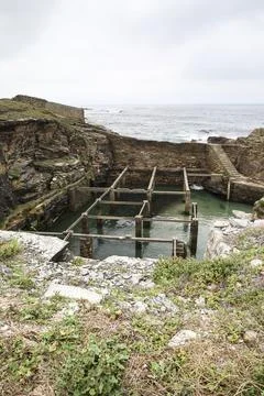 Old natural pool for breeding shellfish in Rinlo town, a small fishing vill.. Stock Photos
