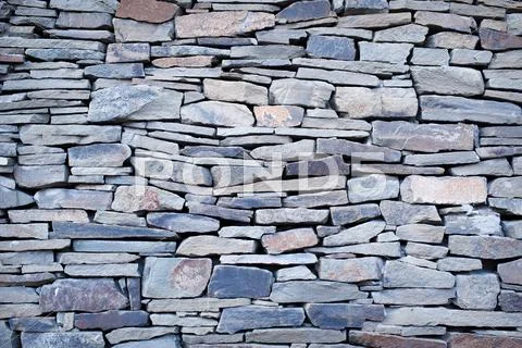 Old Natural stone wall texture for background Stock Photos