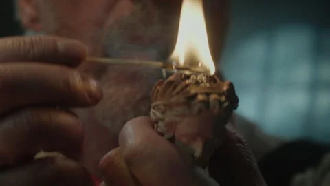 Old navy captain lighting up his pipe 스톡 동영상 259626217