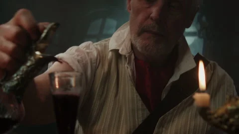 Old navy captain looking at his wine in the glass Video stock 259633694