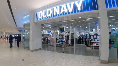 OLD NAVY Store Front in a Shopping Mall With People Passing Stock Footage 105185872