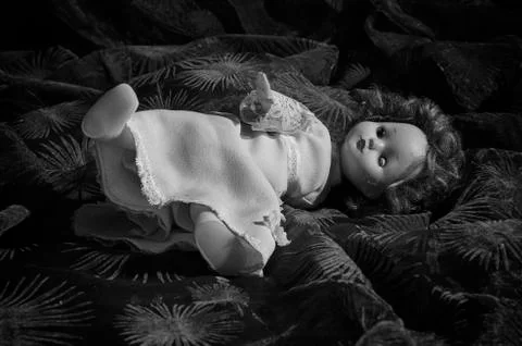 Old, neglected doll. Stock Photos