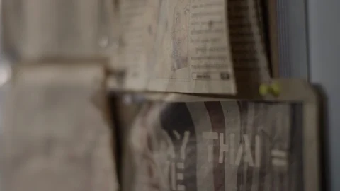 Old newspaper clippsing hang on clipboard in Muay Thai boxing gym Stock Footage 104530451