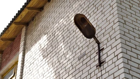 Old, non-working street wall lamp all covered with rust on the wall Stock Footage 211007967