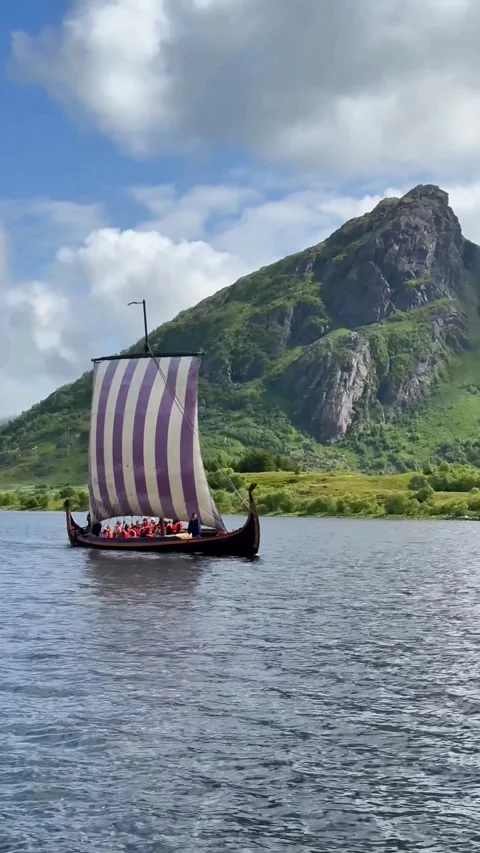 Old Norse vessel navigating tranquil waters with crew. Ancient Viking vessel Stock Footage 327916986