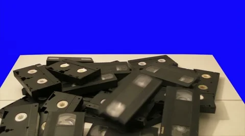 Old Obsolete Crap Defective VHS Video Cassettes - blue screen Stock Footage 8657530