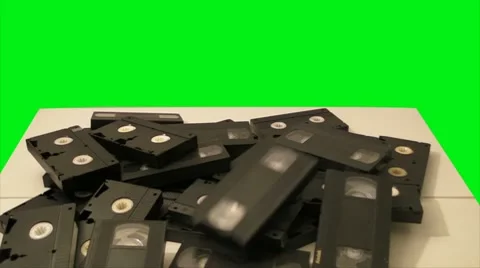 Old Obsolete Crap Defective VHS Video Cassettes - green screen Stock Footage 8657666
