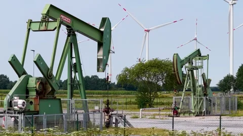 Old Oil Pumpjacks and Wind Turbines Stock Footage 342792885