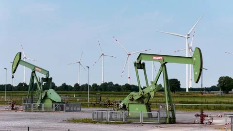 Old Oil Pumpjacks and Wind Turbines Stock Footage 342792887