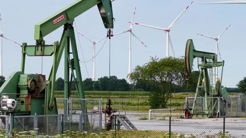 Old Oil Pumpjacks and Wind Turbines Stock Footage 342792888