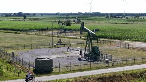 Old Oil Pumpjacks and Wind Turbines Stock Footage 342792890