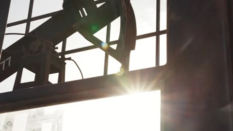 The old oil rig is working, extracting oil.pumping unit and the silhouette .. Stock Footage 232606014