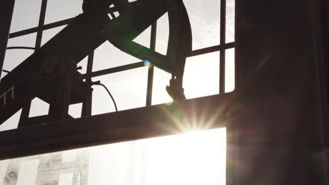 The old oil rig is working, extracting oil.pumping unit and the silhouette .. Stock Footage 232606048