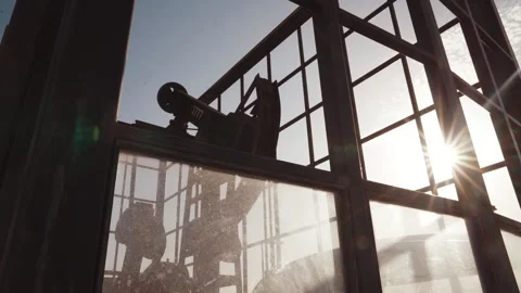 The old oil rig is working, extracting oil.pumping unit and the silhouette .. Stock Footage 232606056