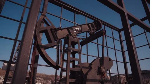 The old oil rig is working, extracting oil.pumping unit and the silhouette .. Stock Footage 232606184