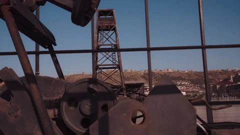 The old oil rig is working, extracting oil.pumping unit and the silhouette .. Stock Footage 232606540