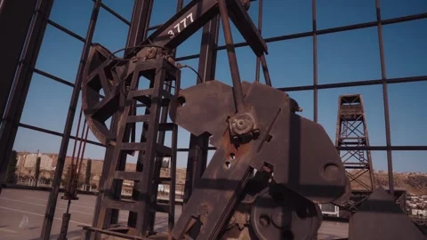 The old oil rig is working, extracting oil.pumping unit and the silhouette .. Stock Footage 232606559