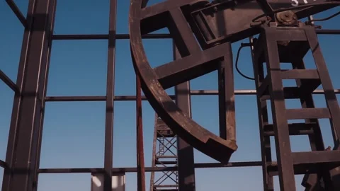 The old oil rig is working, extracting oil.pumping unit and the silhouette .. Stock Footage 232607218