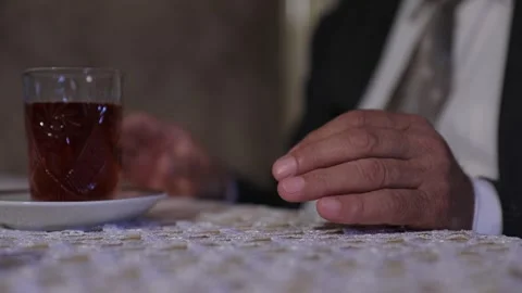 Old old man's hand on the table and a glass of tea Stock Footage 295224530