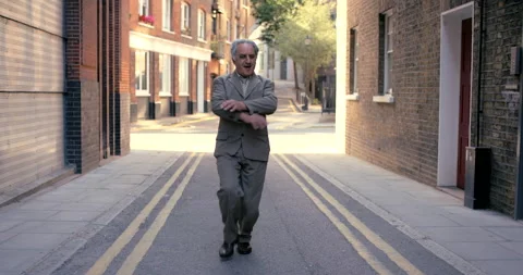 Old is only a state of mind. 4k video footage of a senior man dancing against an Stock Footage 200828757