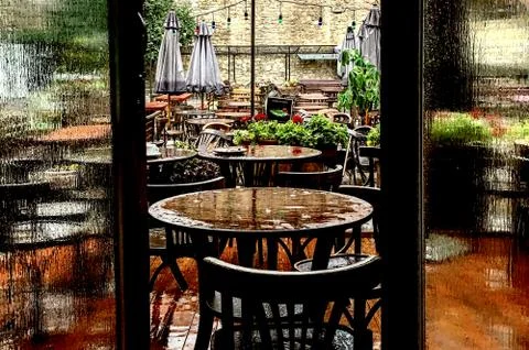 An old open-air cafe, rainy weather, wooden furniture 스톡 사진