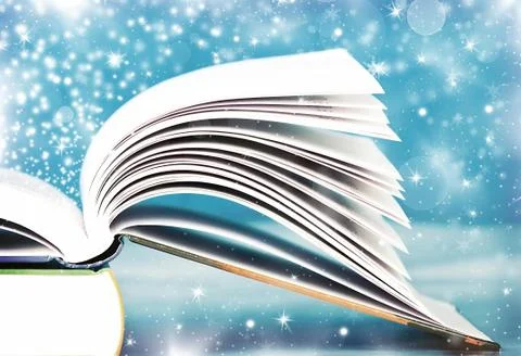 Old open book with magic light and falling stars Stock Photos