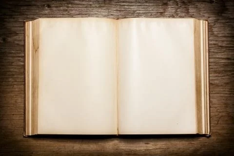 Old open book on the table Stock Photos