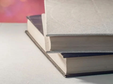 Old open book on windowsill or desk with daylight Stock Photos