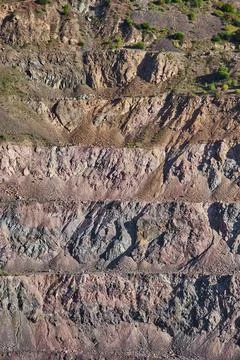 Old open mining pit with pond in mountain Stock Photos