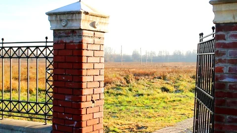 Old openwork gate in the garden closes with a creak Stock Footage 106352532