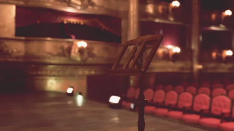 Old opera house stage with music stand and empty red velvet seats 動画素材 286367969