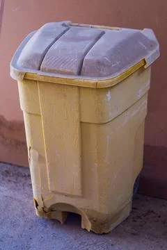 Old orange plastic container for collecting household garbage with black wh.. 写真素材