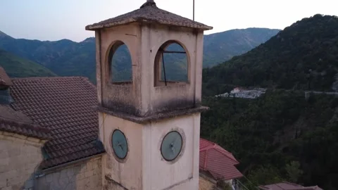 Old Orthodox Bell Tower With Clock Over Mountain Village And Cemetery Stock Footage 326165253