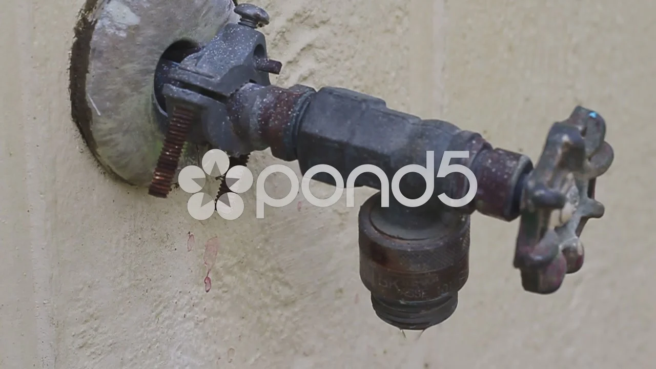 Old Outdoor Faucet Slowly Dripping Water Footage 51744348