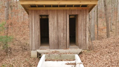 Old outside in the woods an in-ground spring fed white baptistry. Small building Stock Footage 296205313
